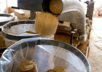 Heat causes lignin in sawdust to breakdown and bind as a 'glue'